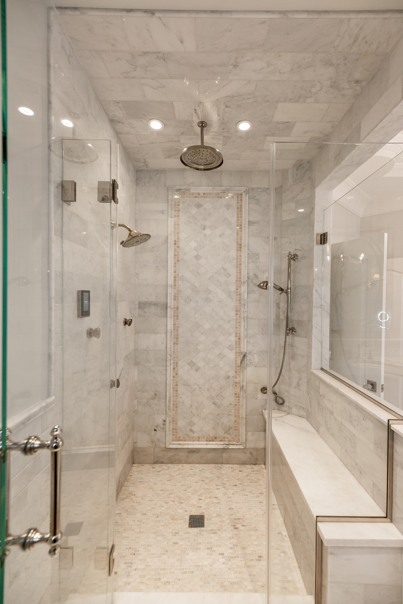 large-primary-bedroom-bathroom-shower-tile-bench