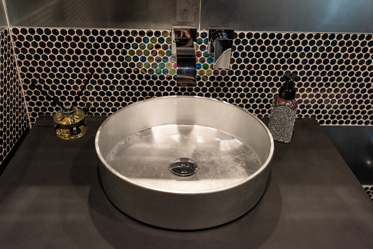 stainless-steel-sink-black-countertop-bathroom-design