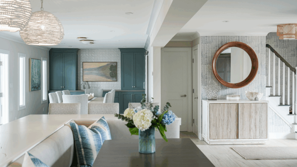 Light-filled entryway and open dining area with soft coastal hues and curated millwork, designed by Melissa Sacco Interiors.
