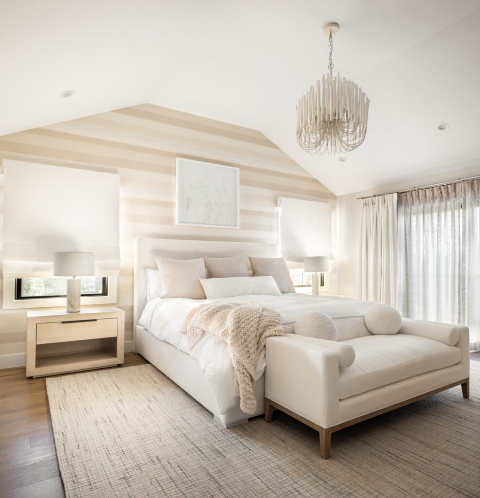 Serene master bedroom with neutral tones, layered textures, and statement chandelier, created through a turnkey full-service interior design process in Long Island.